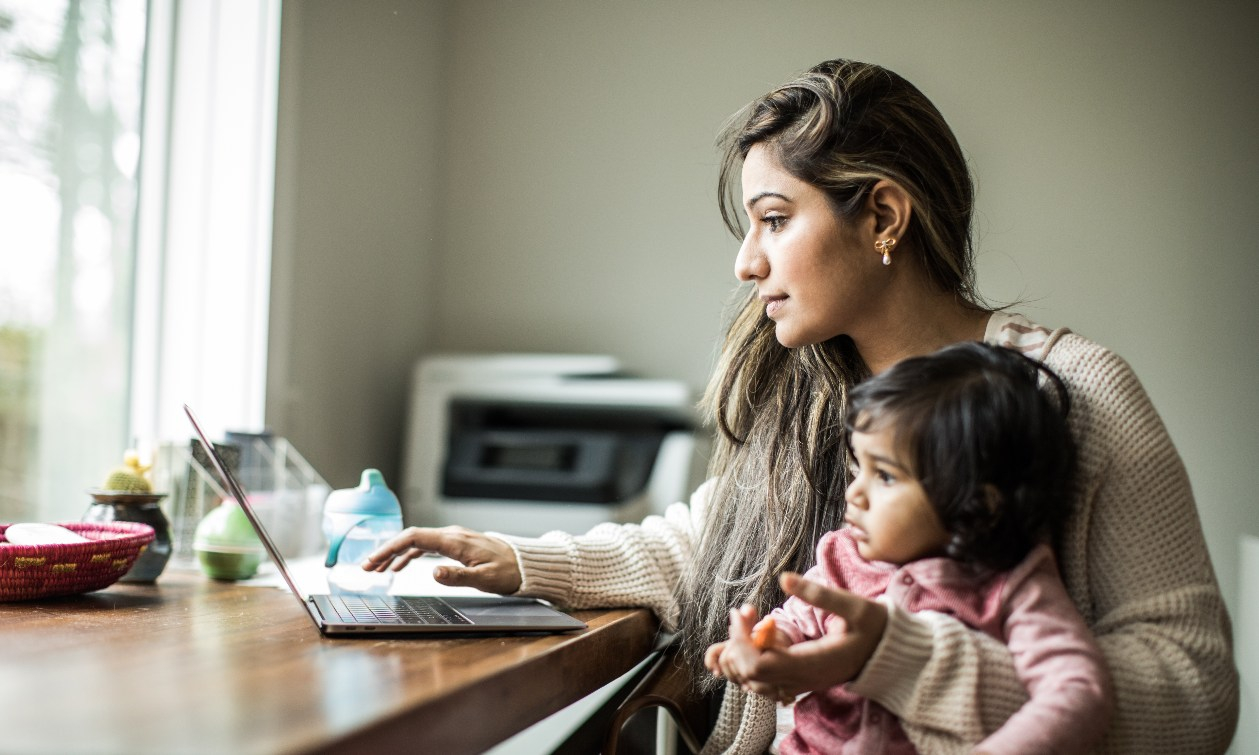 Person using a tablet for everyday digital tasks in a bright living space.