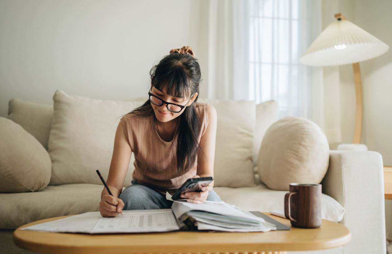 Couple reviewing savings and household finances together at home with a laptop.