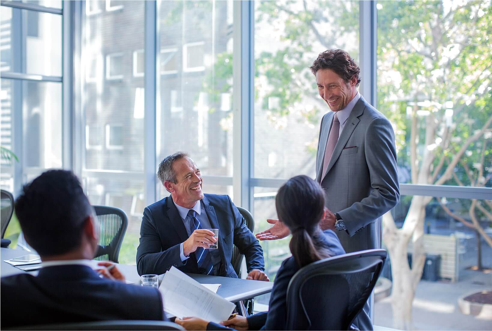 Business colleagues smiling together in a professional office setting.