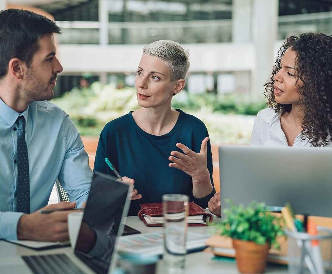 Business colleagues meeting at a table to plan savings and cash management.
