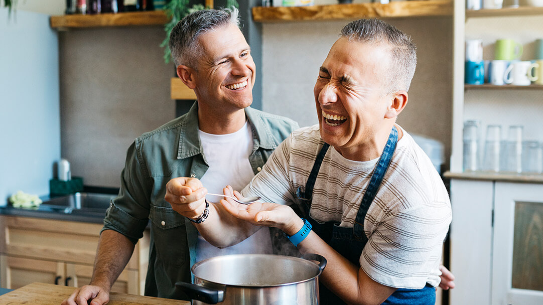 Two people preparing a meal together in a home kitchen.